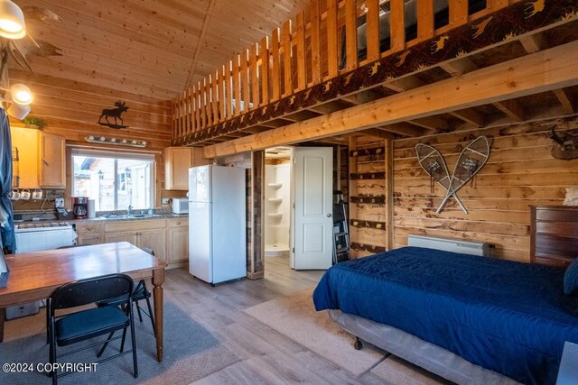 65449 Lingonberry Rd, Ninilchik, AK 99639 - bedroom with a sink, wood ceiling, light wood finished floors, wood walls, and freestanding refrigerator