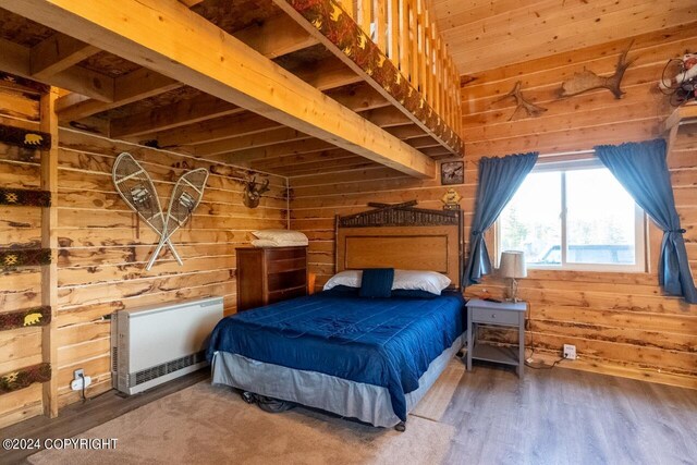 65449 Lingonberry Rd, Ninilchik, AK 99639 - bedroom with wood walls, wood finished floors, and heating unit