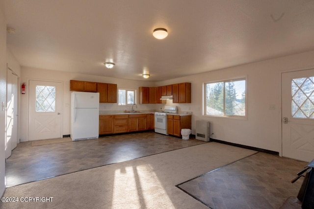 kitchen featuring white appliances and sink