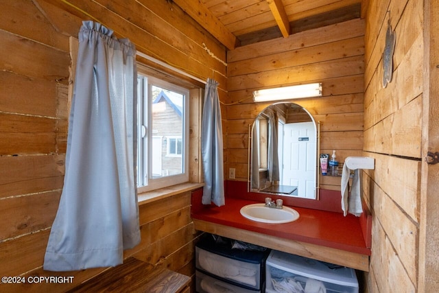 bathroom featuring vanity, wooden ceiling, and wood walls