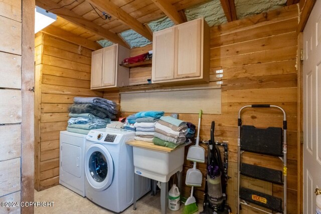 65449 Lingonberry Rd, Ninilchik, AK 99639 - clothes washing area with washing machine and dryer, wooden walls, cabinet space, and wooden ceiling