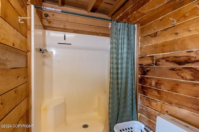 bathroom with toilet, walk in shower, and wooden walls