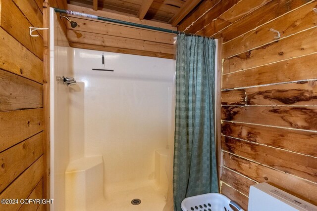 65449 Lingonberry Rd, Ninilchik, AK 99639 - full bathroom featuring toilet, wood walls, and a stall shower