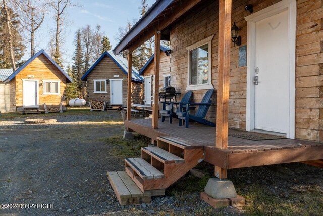 65449 Lingonberry Rd, Ninilchik, AK 99639 - wooden deck featuring an outdoor structure