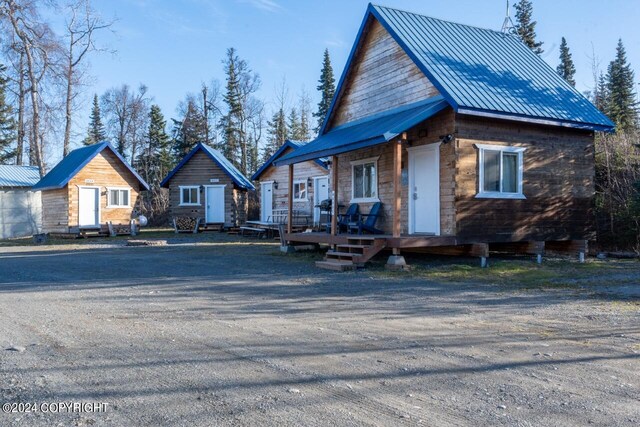 65449 Lingonberry Rd, Ninilchik, AK 99639 - view of front of property with a wooden deck and metal roof