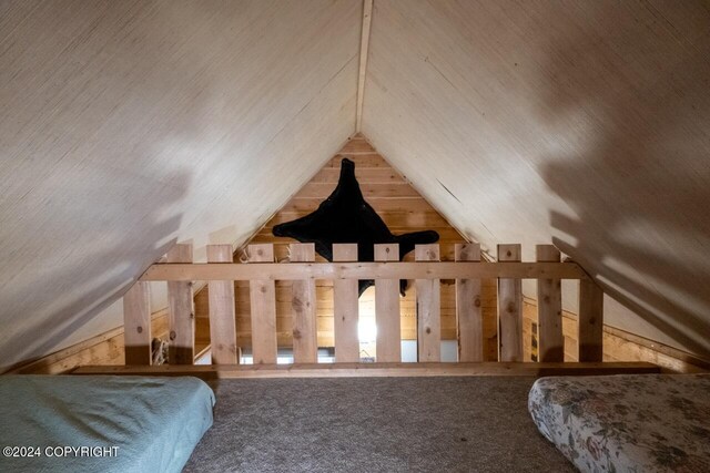 65449 Lingonberry Rd, Ninilchik, AK 99639 - unfurnished bedroom with lofted ceiling, wooden walls, and carpet