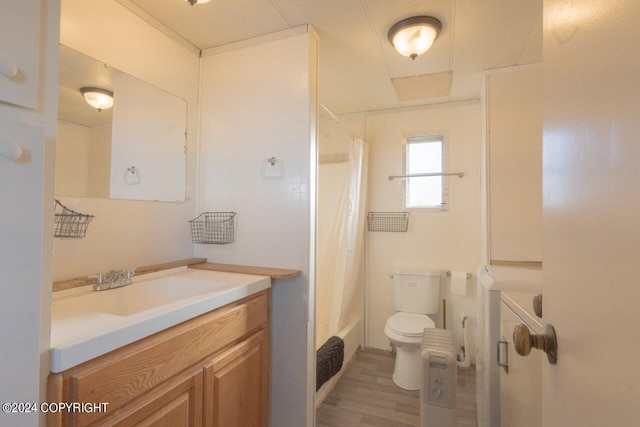 full bathroom with vanity, toilet, hardwood / wood-style flooring, and shower / bathtub combination with curtain