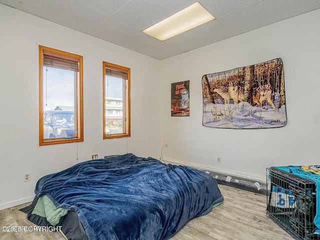 bedroom with baseboards and wood finished floors