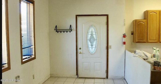 entrance foyer with baseboards and light tile patterned flooring
