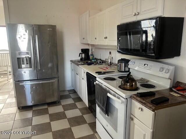 kitchen with white cabinetry, black appliances, and light floors
