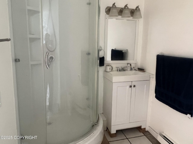 bathroom featuring a shower stall, tile patterned flooring, vanity, and baseboard heating