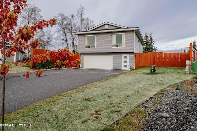 view of front of house with a front lawn and a garage