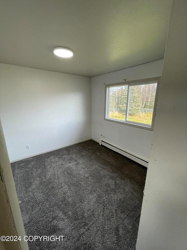 carpeted empty room with baseboard heating