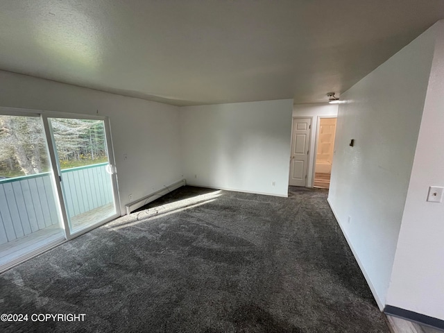 spare room featuring carpet flooring and a baseboard radiator