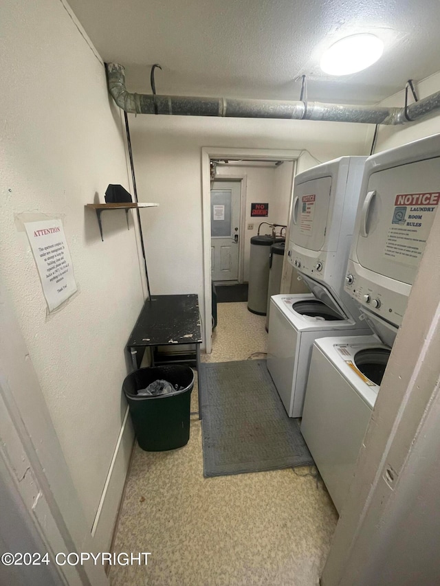 clothes washing area with washer / dryer and a textured ceiling