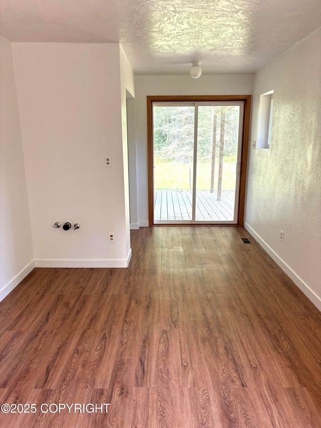 7025 S Gilleys Cir, Wasilla, AK 99654 - unfurnished room with wood finished floors and a textured ceiling