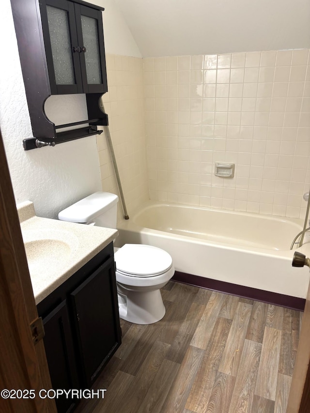 7025 S Gilleys Cir, Wasilla, AK 99654 - bathroom with vanity, wood finished floors, and lofted ceiling