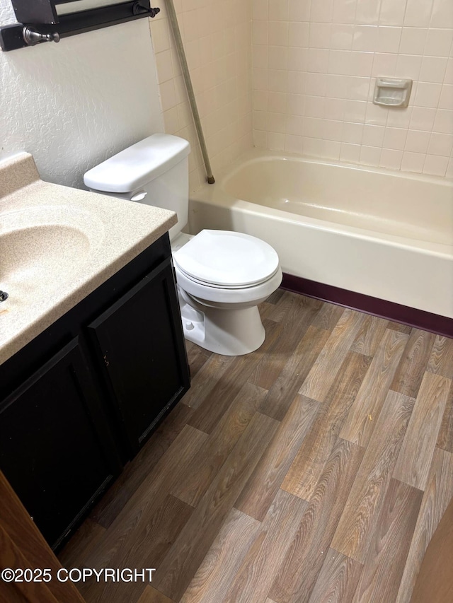 7025 S Gilleys Cir, Wasilla, AK 99654 - bathroom featuring vanity, wood finished floors, and shower / tub combination