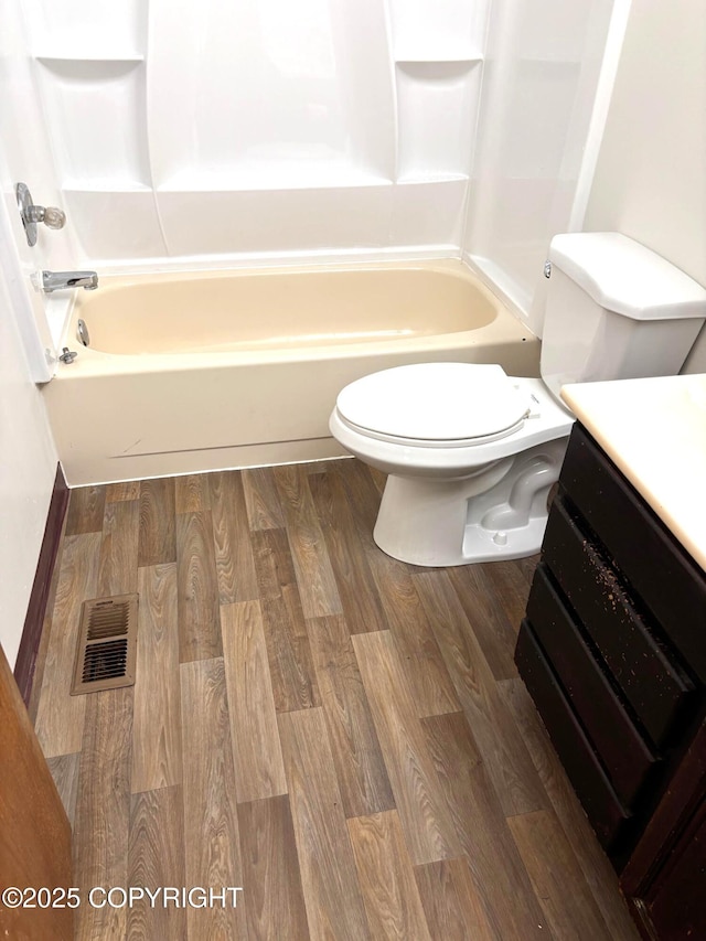 7025 S Gilleys Cir, Wasilla, AK 99654 - bathroom featuring vanity, washtub / shower combination, and wood finished floors