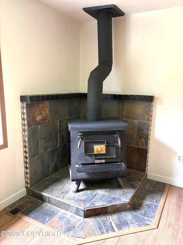 7025 S Gilleys Cir, Wasilla, AK 99654 - detailed view of a wood stove and wood finished floors