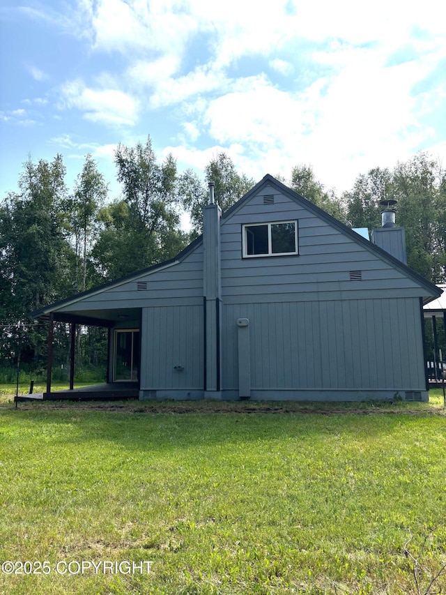 7025 S Gilleys Cir, Wasilla, AK 99654 - view of property exterior with a chimney and a lawn