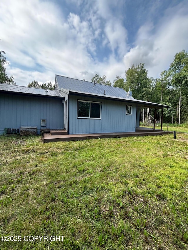 7025 S Gilleys Cir, Wasilla, AK 99654 - back of house featuring a yard, a metal roof, and a wooden deck