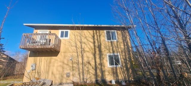 view of home's exterior with a balcony