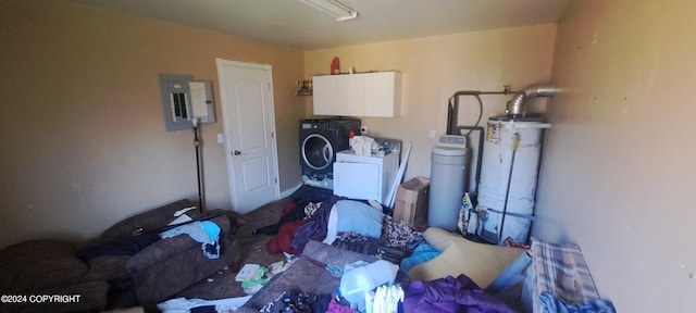 washroom featuring water heater, washer and clothes dryer, electric panel, and cabinets