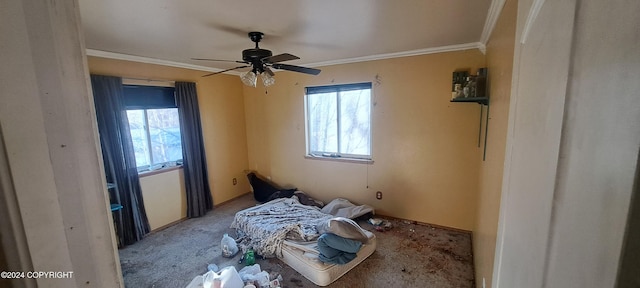 interior space with ornamental molding, carpet flooring, and ceiling fan