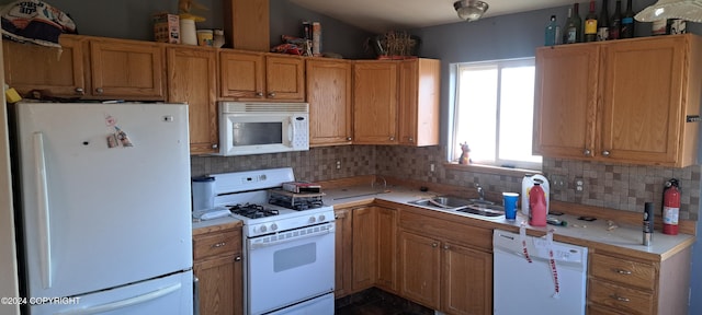 kitchen with sink, white appliances, and tasteful backsplash