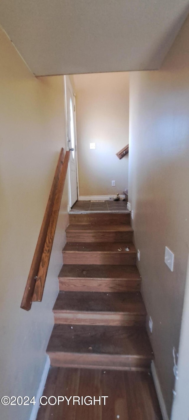 stairway featuring hardwood / wood-style floors