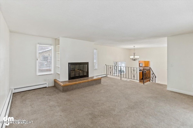 unfurnished living room with a textured ceiling, carpet floors, and a baseboard heating unit