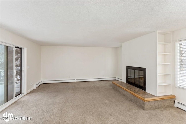 unfurnished living room with a textured ceiling and carpet