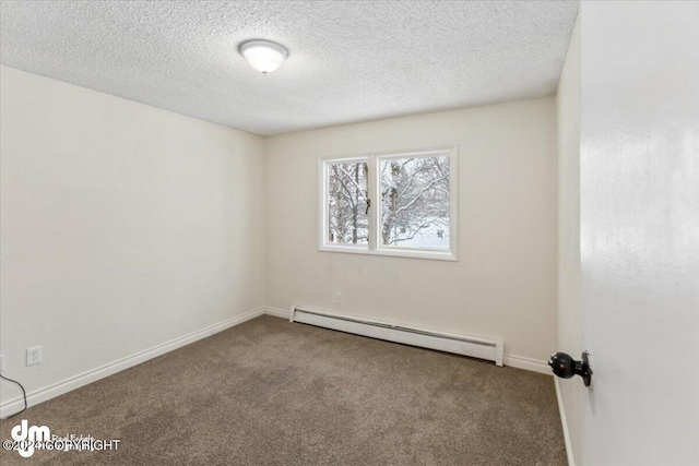 carpeted spare room with a textured ceiling and a baseboard heating unit