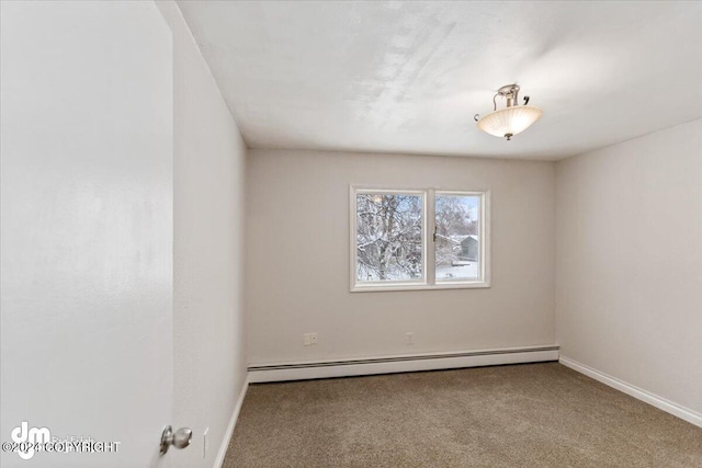 carpeted spare room featuring a baseboard radiator