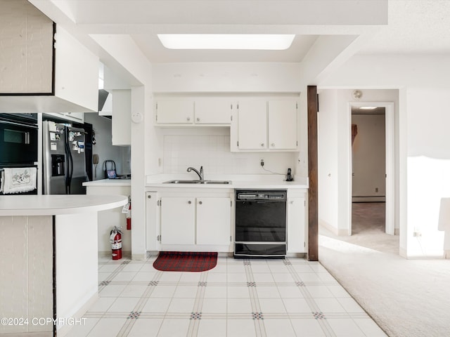 kitchen with white cabinetry, sink, black dishwasher, stainless steel fridge with ice dispenser, and a baseboard heating unit