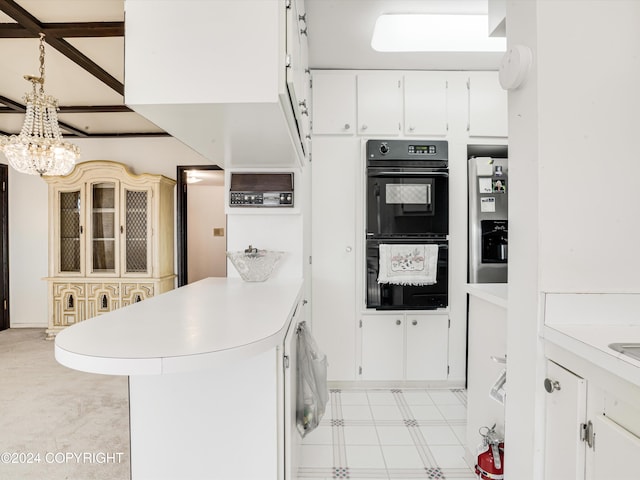 kitchen with black double oven, white cabinets, stainless steel refrigerator with ice dispenser, and an inviting chandelier