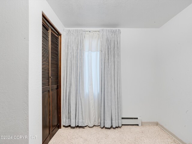 unfurnished bedroom with a textured ceiling and a closet