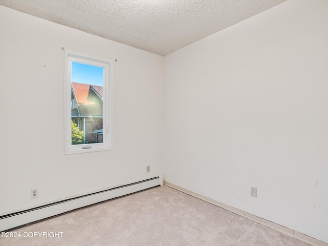 carpeted spare room featuring a textured ceiling and a baseboard radiator