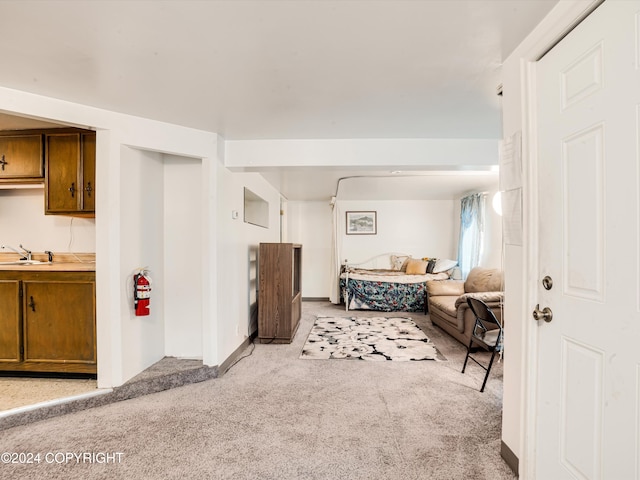 carpeted bedroom featuring sink