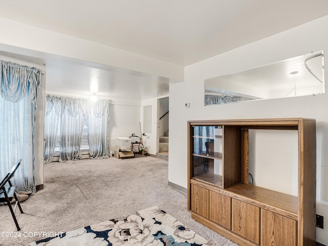 unfurnished living room featuring light carpet