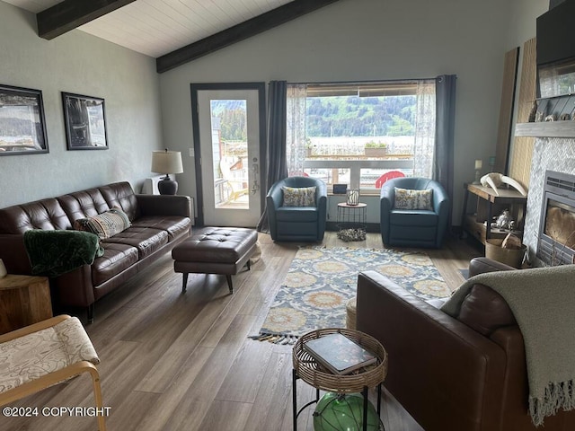 living room with hardwood / wood-style flooring, lofted ceiling with beams, wood ceiling, and a fireplace