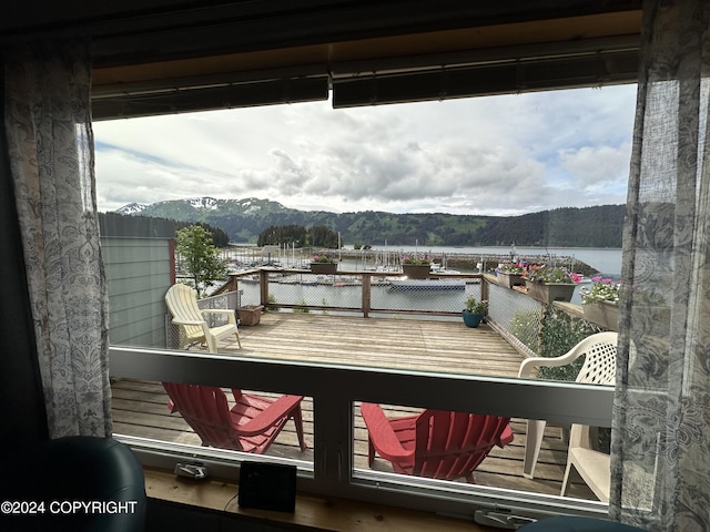 balcony featuring a water and mountain view