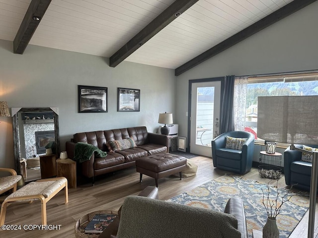 living room with vaulted ceiling with beams and wood-type flooring