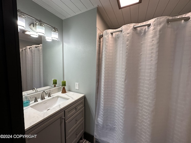 bathroom featuring a shower with shower curtain, vanity, and wood ceiling