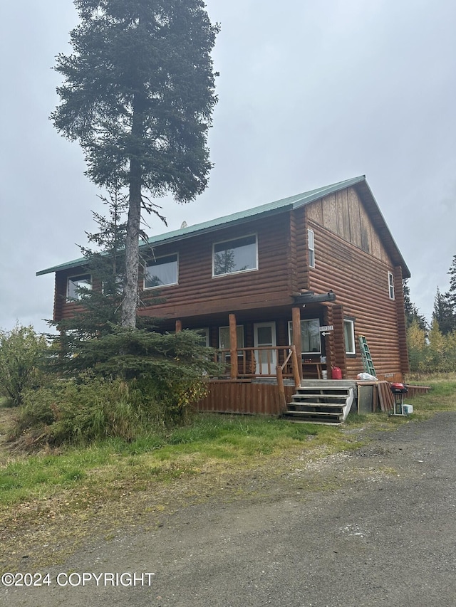 28160 Chestes St, Ninilchik, AK 99556 - view of front facade with covered porch and board and batten siding