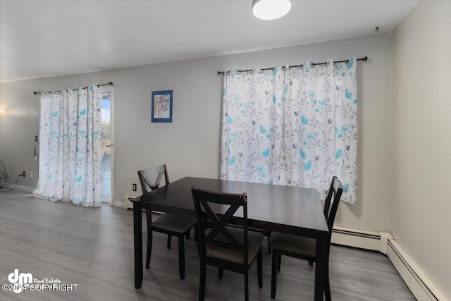 dining space featuring hardwood / wood-style floors and a baseboard radiator