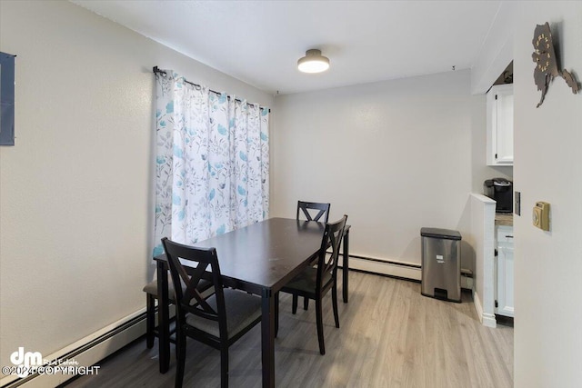 dining room featuring baseboard heating and light wood-type flooring