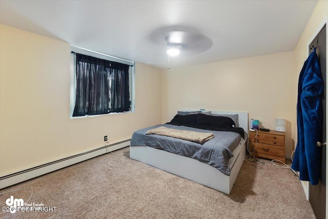 3591 Lynn Dr # 1, Anchorage, AK 99508 - bedroom with baseboard heating, carpet floors, and a ceiling fan