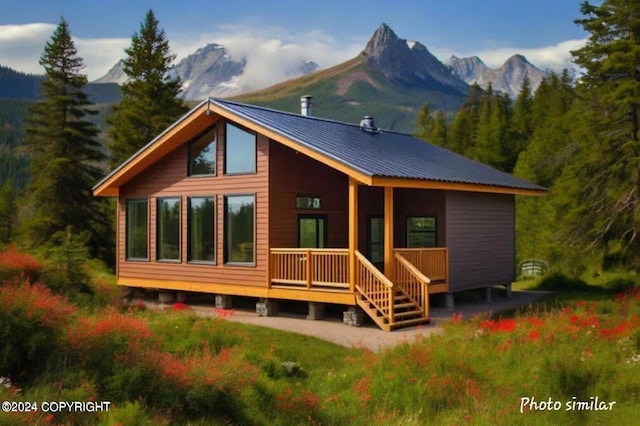 rear view of property with a mountain view